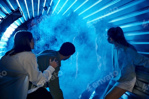 Preview: scared diverse friends standing in tunnel near freaky people in gas masks, quest room participation