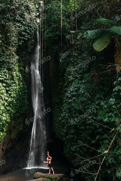 Preview: Couple at a tropical waterfall. The couple travels to the island of Bali in Indonesia