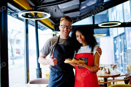 Preview: Cheerful adult multiracial employees in modern pastry shop