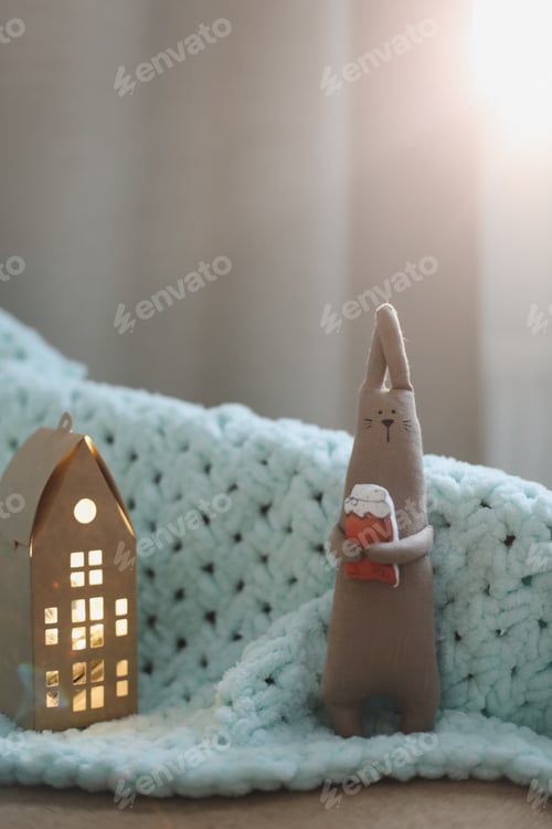 Preview: Cute lovable little rabbit toy in a cozy nursery. hare is a symbol of the new year. Baby shower