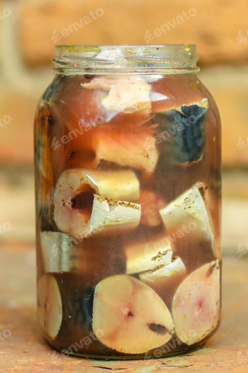 Preview: Mackerel, Fresh Salted Fish In A Jar (Pieces In Brine). Top View. Food Background