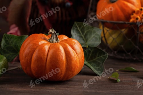Preview: Pumpkins and leaves over wooden background copy space