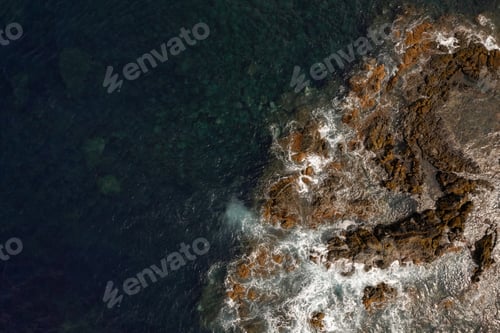 Preview: Rocky coast of wavy sea with foamy waves