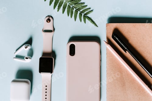 Preview: Pink and blue flat lay home office with modern gadgets such as smartphone, earphones, notepad