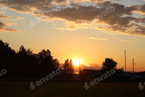 Preview: Sun setting behind numerous bright clouds