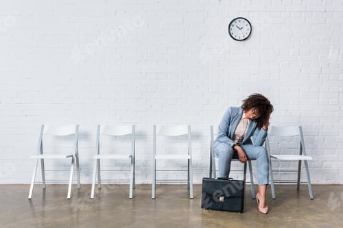 Preview: Tired female candidate with briefcase waiting for interview