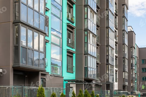 Preview: Side view of modern apartment building with glass balconies