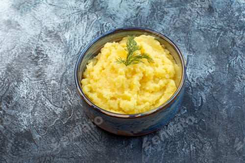 Preview: Top view of mashed potatoes served with dill on dark color background with free space