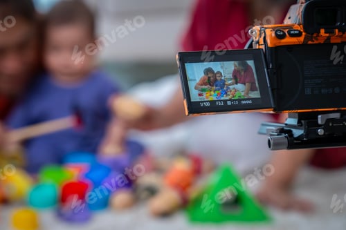 Preview: A man and a woman are playing with a baby and a bunch of toys. The baby is looking at the camera and