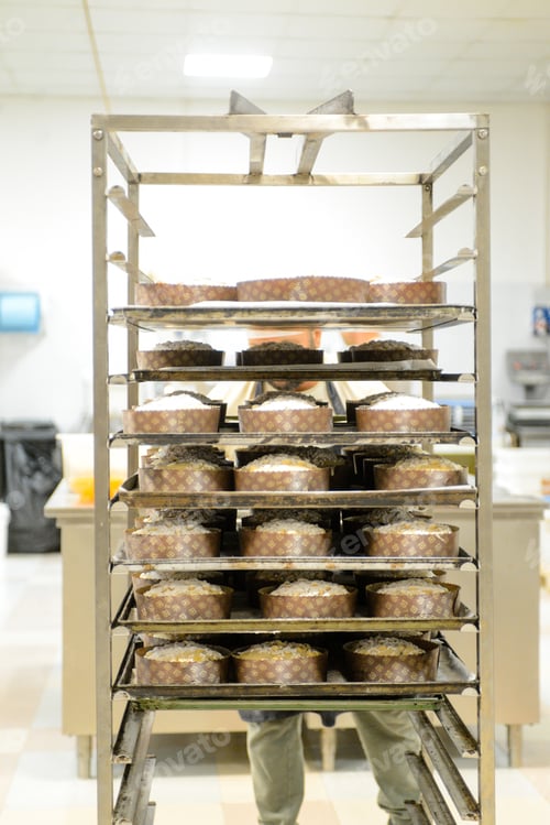 Preview: chef producing panettone, while lievitate, adding almond sugar topping to raw sweet bread.