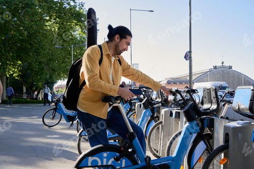 Preview: A man is standing next to a bike to rent o share