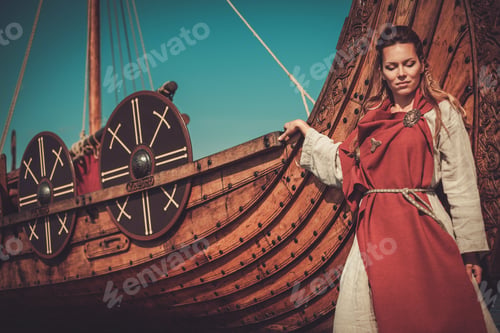 Preview: Viking woman in traditional clothes near drakkar