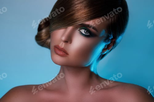 Preview: Model in stylish image with sleek hair covering one eye and beautiful green eyeshadows on another
