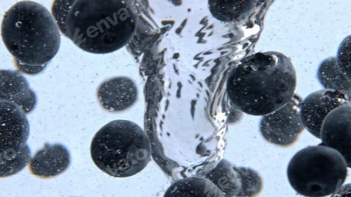 Preview: Bubbled aqua making funnel with berries closeup. Fruit cocktail spinning vessel
