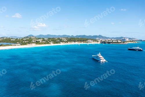 Preview: a group of boats sail in a large open blue ocean