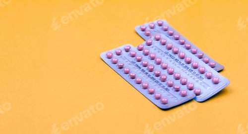 Preview: Blister packs of contraceptive pills on yellow background. Hormone pills for treatment hormone acne