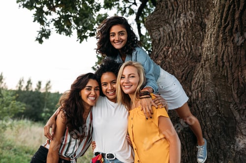Preview: Young beautiful women looking at the camera. Group of females spending time out of town.