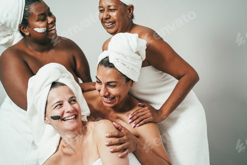 Preview: Laughing Women Wrapped in Towels Enjoying Spa Day