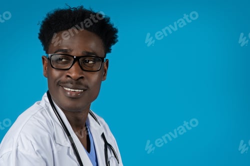 Preview: Portrait of young handsome black doctor wearing eyeglasses on blue