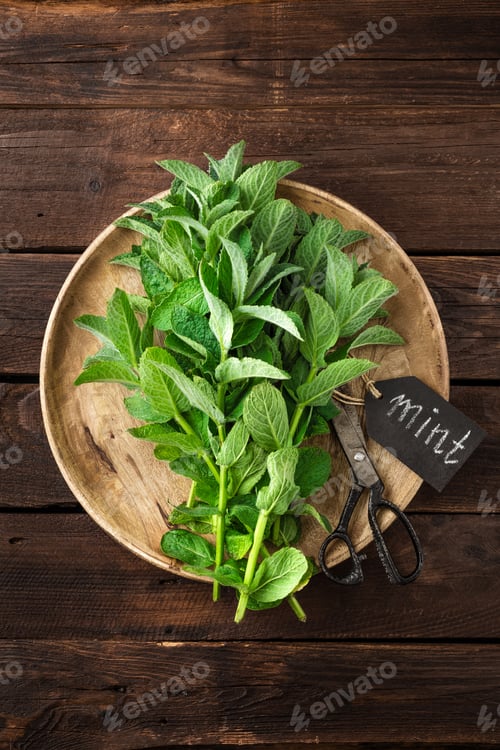 Preview: Fresh mint leaves on wooden rustic table, top view
