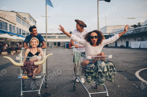 Preview: Young friends racing with shopping carts