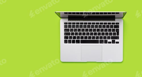 Preview: A laptop placed against a green background in a flat lay style