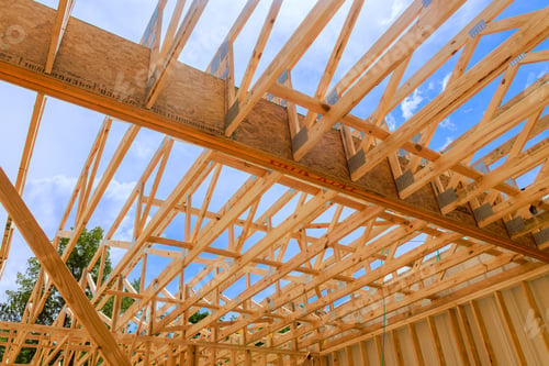 Preview: Construction of wooden trusses framework under bright blue sky at residential building site