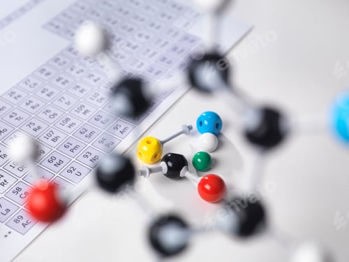 Preview: Molecular model next to periodic table on lab bench