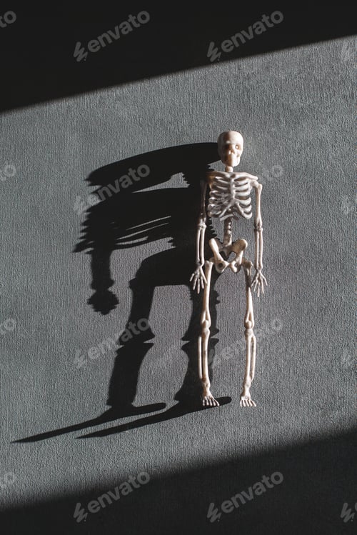 Preview: Toy skeleton over grey background, minimalistic Halloween concept, top view flat lay