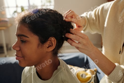 Preview: Mother making hairstyle to her adopted daughter