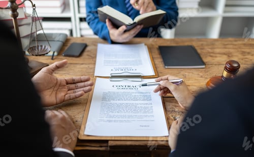 Preview: Lawyer is giving legal advice to a businessman in the legal counsel's office.