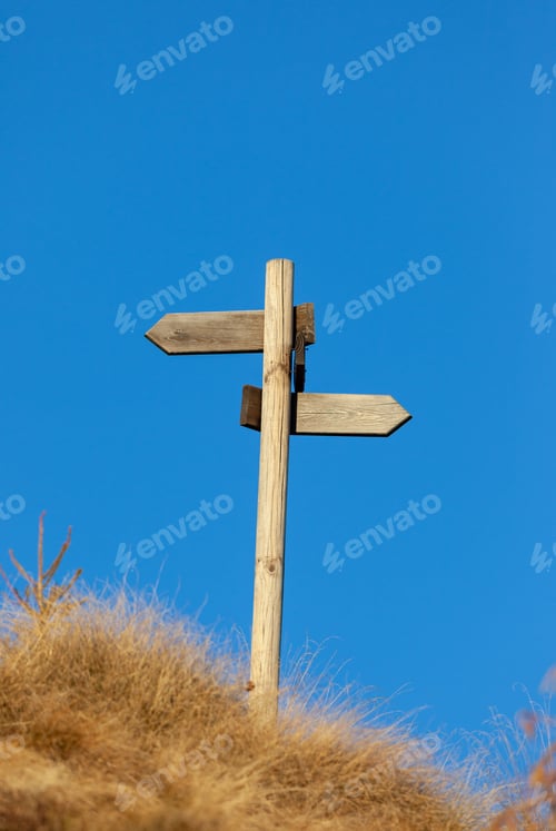 Preview: Wooden signpost and blue sky. Copy space on the top.