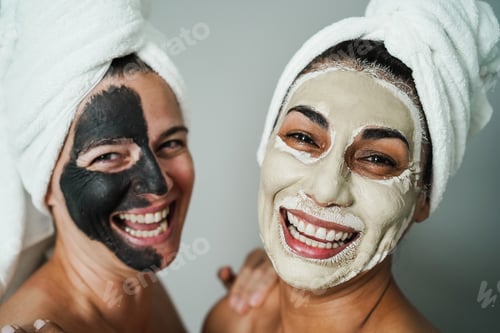 Preview: Senior women doing beauty treatment using beauty skin masks - Focus on right female face
