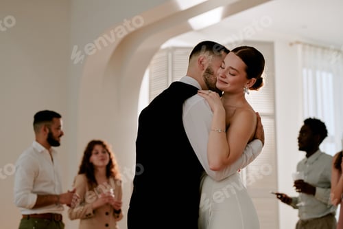 Preview: Young Caucasian Bride and Groom Embracing during Wedding Celebration Indoors