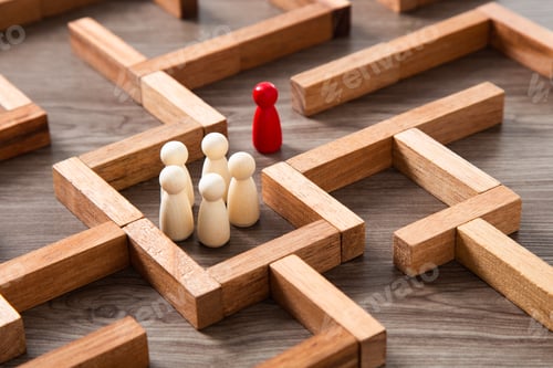 Preview: Wooden miniature at the start point of puzzle maze wood block. Leadership concept.