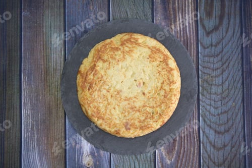 Preview: Tasty cake with egg yolk on a wooden table
