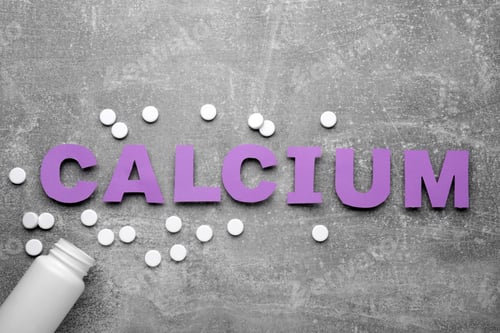 Preview: Word Calcium made of violet paper letters, medical bottle and pills on gray background, top view