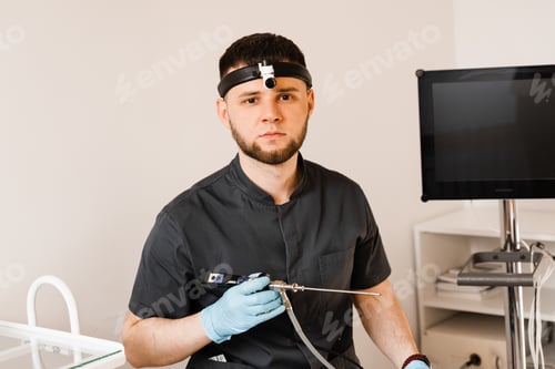 Preview: Young Adult Male Doctor with Medical Instrument