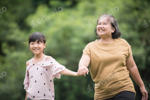 Preview: Grandmother Playing With Granddaughter Outdoors At The Park