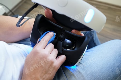Preview: Man cleaning virtual reality glasses