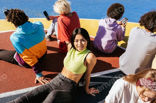 Preview: Multiracial group of young friends bonding outdoors