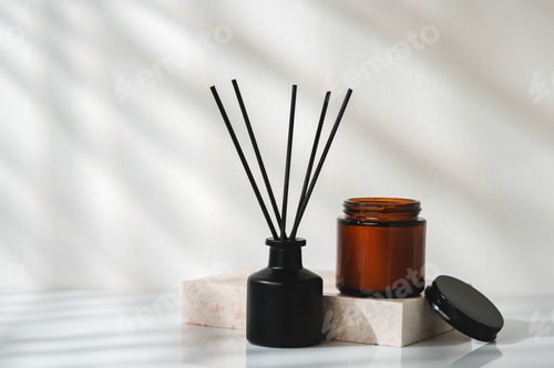 Preview: Elegant Aroma Diffuser With Black Reeds on a Marble Stand in Soft Daylight