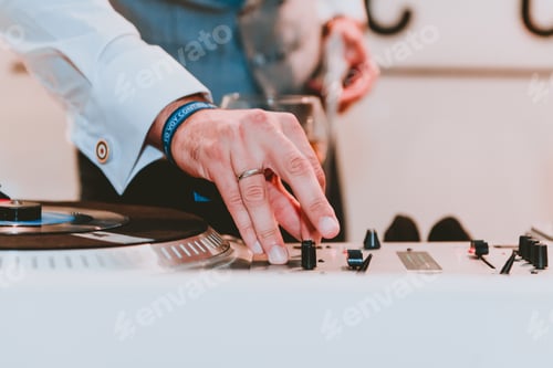 Preview: Man using music equalizer near glass of drink