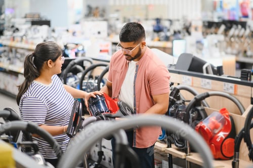 Preview: Indian Couple choosing vacuum cleaner, electronics store