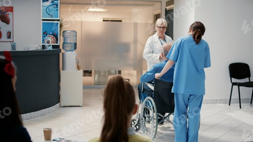 Preview: Senior physician talking to retired man with disability at hospital reception