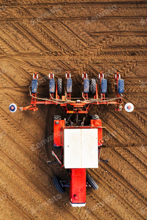 Preview: Top view of tractor with seeder from drone pov
