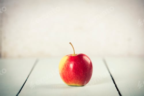 Preview: Apple on white wooden background, space for text
