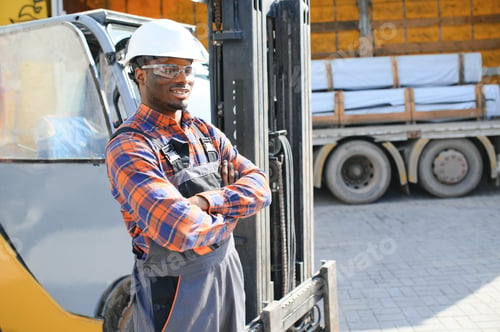 Preview: Portrait of a happy African American male worker driving forklift at workplace