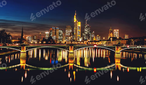 Preview: Frankfurt skyline at night with reflections.