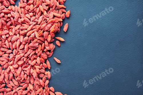 Preview: Goji in bowl on wood table. Top view of fresh goji in scoop and bowl. Goji in heart shape on table.